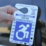 Somebody holding a parking permit.