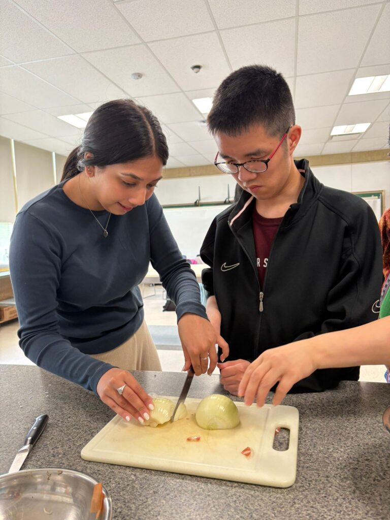Two People Cutting Onions